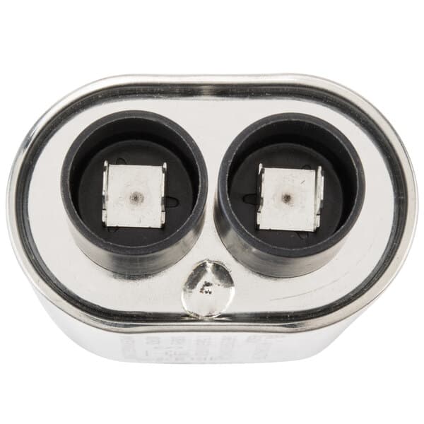 A close up of a Solwave high voltage capacitor with black and white sockets.