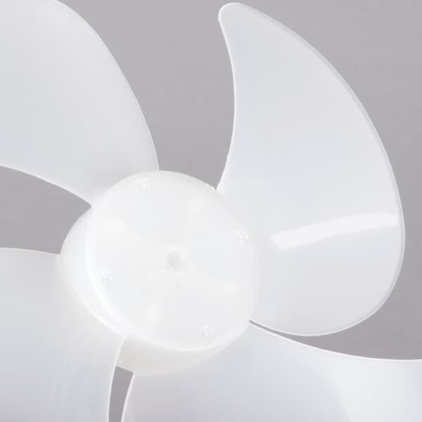 A close-up of a white plastic fan blade.