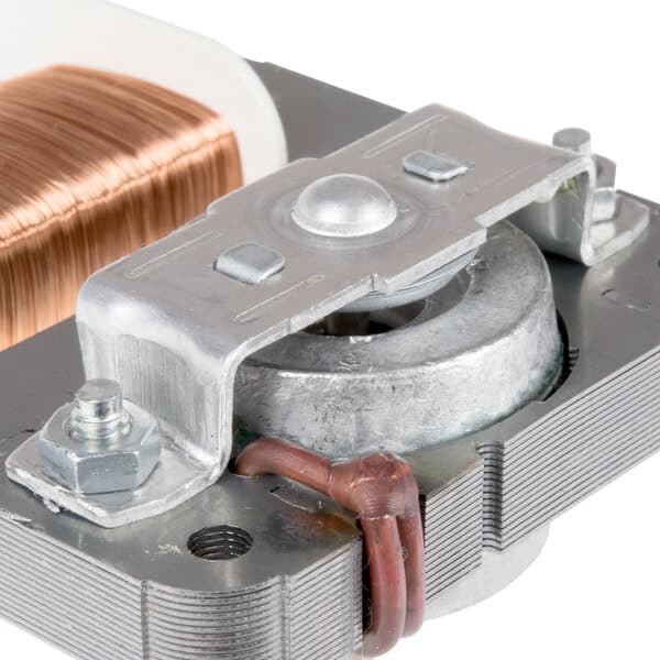 A close-up of a metal part with a copper coil and copper wire.