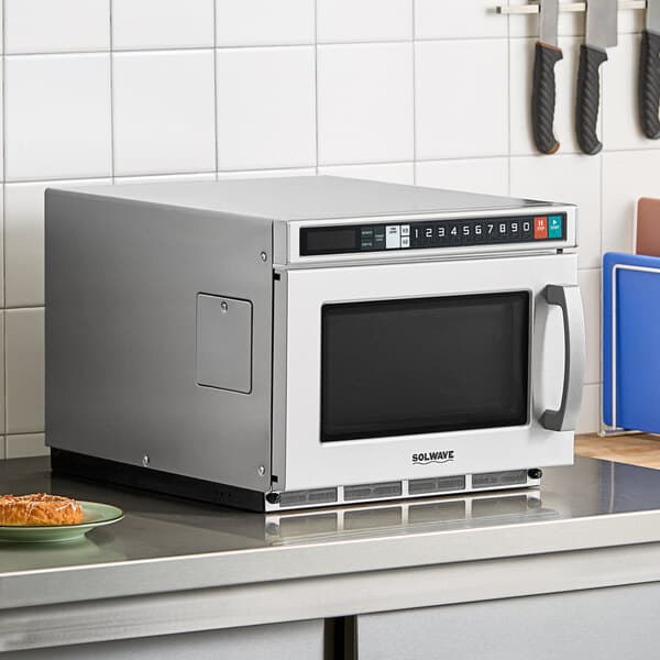 A Solwave stainless steel commercial microwave on a counter.