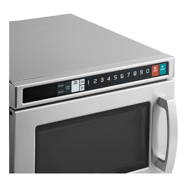 A close-up of a Solwave Space Saver stainless steel commercial microwave with a digital display.
